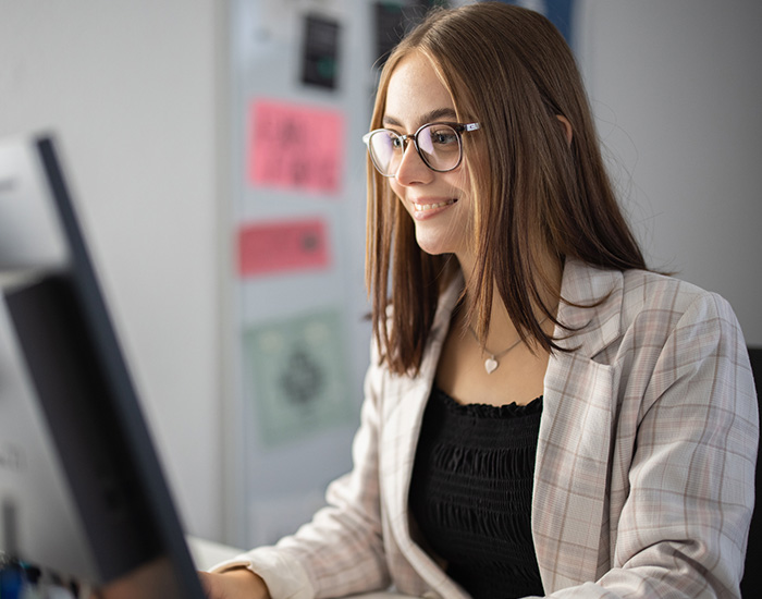 young woman working from home wearing glasses