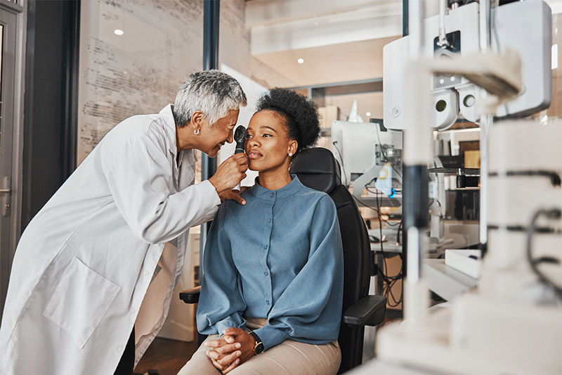 woman getting eyes checked by eye doctor