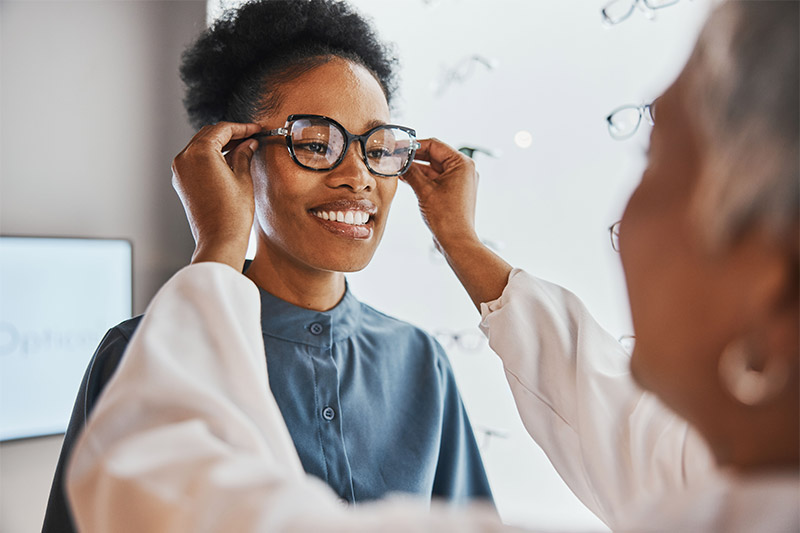 woman getting fitted for glasses