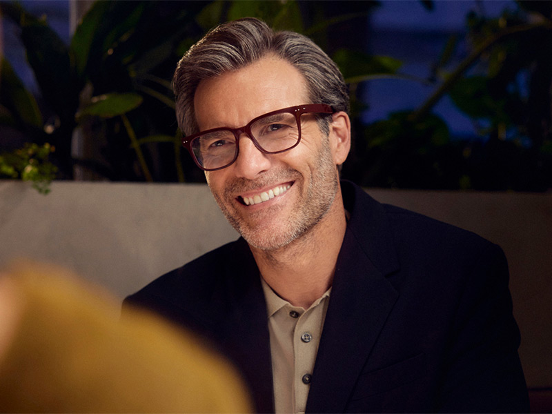 Person wearing glasses smiling indoors